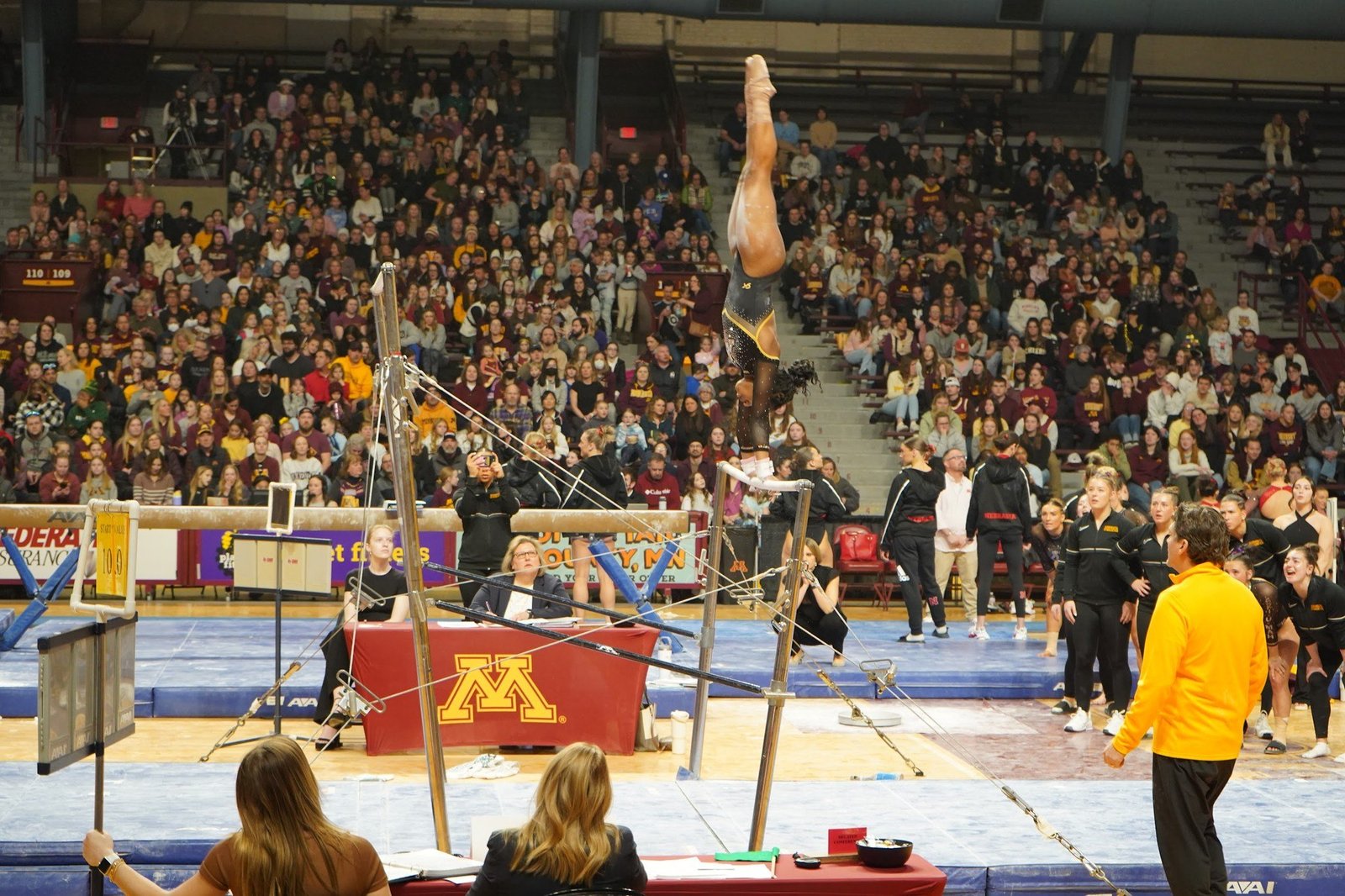 Teryn Crump on uneven bars at a home meet